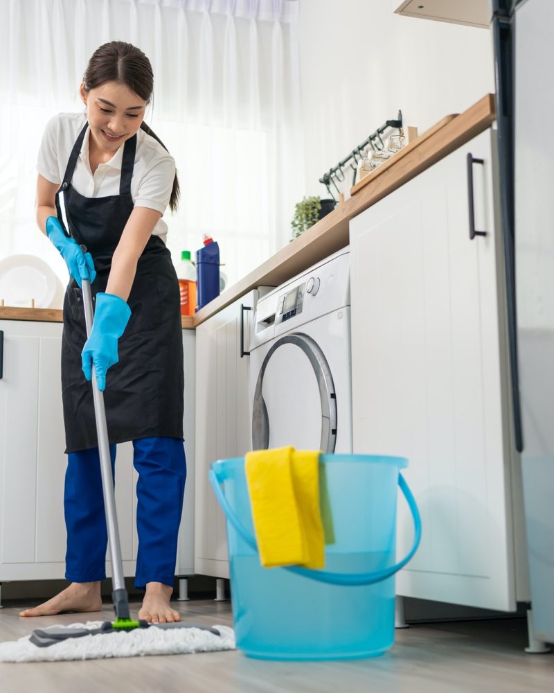 asian-active-cleaning-service-woman-worker-cleaning-feel-happy-in-kitchen-at-home-