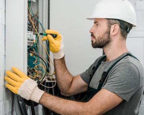 side-view-of-handsome-bearded-electrician-repairin-resize-pyzlpgdjenir7l7pyfa5n64n33vby8a9nm3f6ejonc