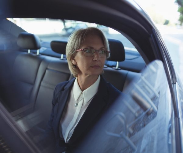 Thoughtful businesswoman traveling in car