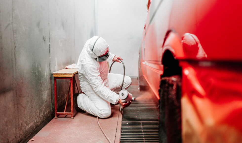 close up details of industrial worker, mechanic engineer painter using a spray brush gun and painting a car close up details of industrial worker, mechanic engineer painter using a spray brush gun and painting a car